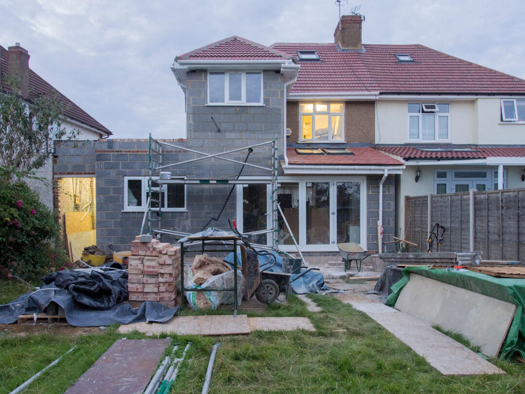 House Renovation Specialists Sydney | Complete Home Renovation Services Residential house renovation in progress featuring a home extension, scaffolding, construction materials, and exterior building works, showcasing complete house renovation services in Sydney.